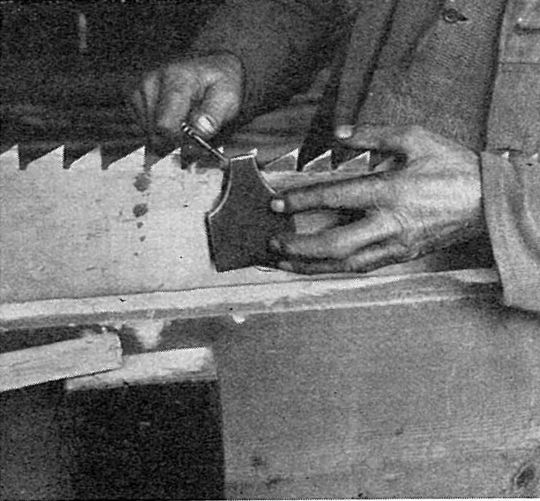 Foto Schränken einer Säge mit Schränkeisen und Schränklehre